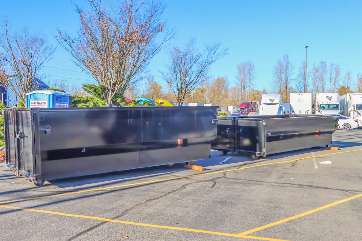 Professional dumpster rental service with roll-off container on residential driveway in Lower Moreland
